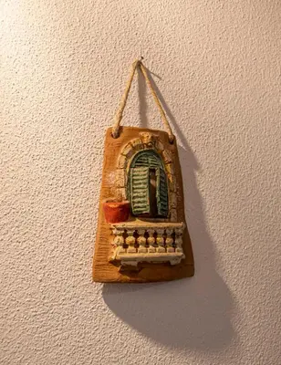 a small window ornament hanging on a wall at L'angolo di Leo in Isola delle Femmine