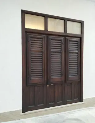 a pair of wooden doors on a building at Casa vacanze LoRiLù in Castellammare del Golfo