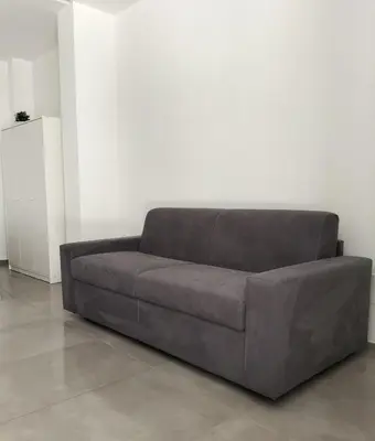 a brown couch sitting in a living room at Casa vacanze LoRiLù in Castellammare del Golfo
