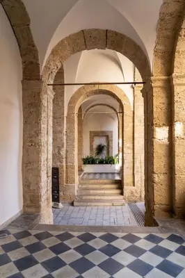 an arcade in a building with a checkered floor at Boutique Apartment 