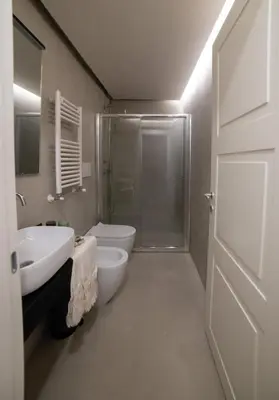 a bathroom with a shower and a sink and a toilet at Boutique Apartment 