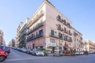 a large building with cars parked in front of it at Sella Apartment Centro Storico in Palermo