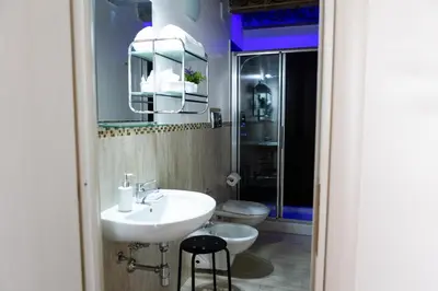 a bathroom with a sink and a toilet and a mirror at Ai Mercati di Palermo in Palermo
