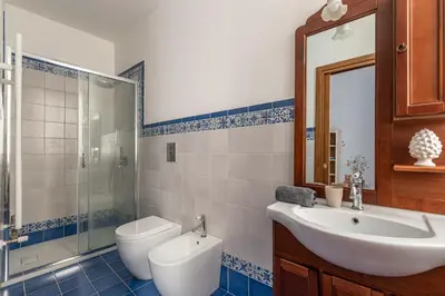 a bathroom with a sink and a toilet and a mirror at Il Cortile degli Aragonesi by Wonderful Italy in Palermo