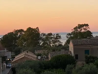 a sunset over a city with houses and trees at marinellahomeandsea in Palermo