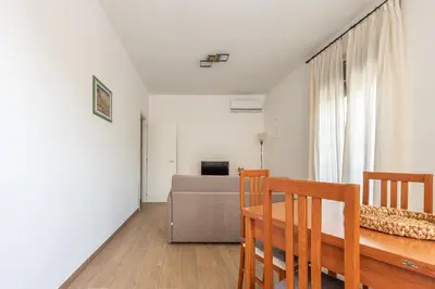 a living room with a table and a couch at La Casetta Donna Vita a Mondello by Wonderful Italy in Palermo
