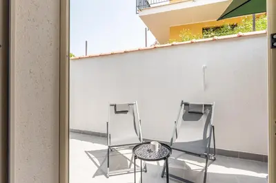 two chairs and a table on a balcony at La Casetta Donna Vita a Mondello by Wonderful Italy in Palermo