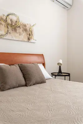 a bedroom with a bed and a painting on the wall at La Casetta Donna Vita a Mondello by Wonderful Italy in Palermo