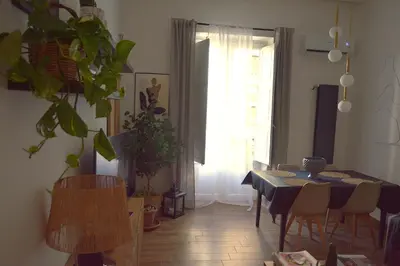 a dining room with a table and chairs and a window at Suite 374 in Palermo