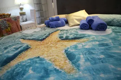 a bedroom with a bed with a starfish on it at Mondello House Lemon in Palermo