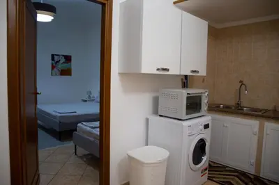 a kitchen with a washing machine and a microwave at La Casetta della Nonna in Palermo