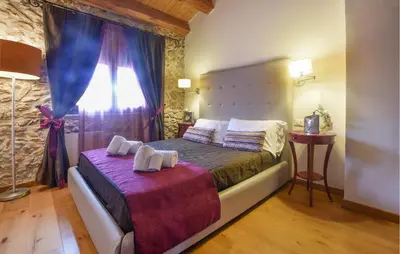 a bedroom with a bed with purple sheets and a window at Nice Home In Partinico With Wifi in Partinico