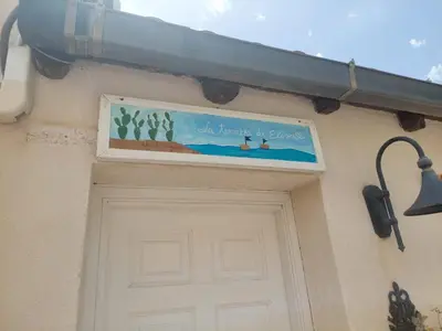 a sign above a door with a light above it at La Terrazza su Mondello in Palermo