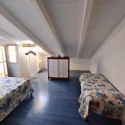 a room with two beds and a dresser in it at La Terrazza su Mondello in Palermo