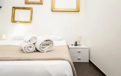 a bedroom with a bed with towels on it at Maison d'art Orleans in Palermo