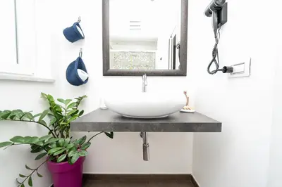 a bathroom with a sink and a mirror at Maison d'art Orleans in Palermo