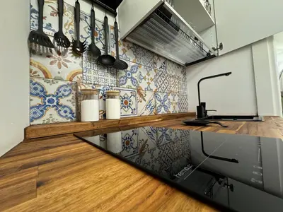 a kitchen with blue and white tiles on the wall at ArcorosaApartment Palermo Centro in Palermo