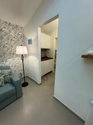 a living room with a blue couch and a lamp at ArcorosaApartment Palermo Centro in Palermo