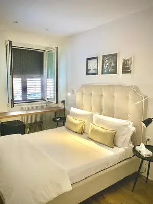 a bedroom with a large white bed with two pillows at Normanni 5 Rooms & Apartment in Palermo