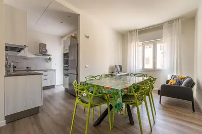 a kitchen and dining room with a table and chairs at Appartamento Pacini by Wonderful Italy in Palermo