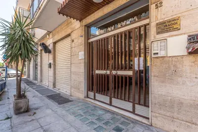 a building with a gate on the side of a street at Appartamento Pacini by Wonderful Italy in Palermo