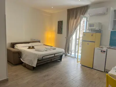 a bedroom with a bed and a refrigerator at Home al Capo by Holiday World in Palermo