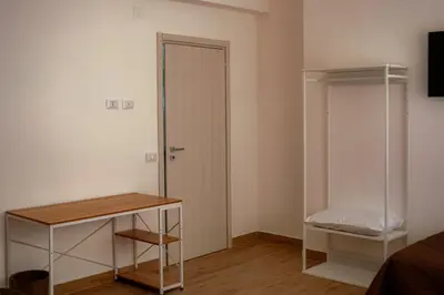 a room with a closet and a door and a table at Casa Margherita in Termini Imerese