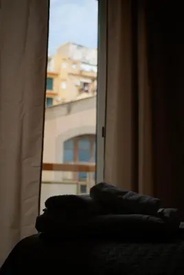 a window with two pillows sitting on top of a bed at Casa Margherita in Termini Imerese