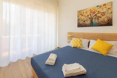 a bedroom with a blue bed with two towels on it at Anna's Central Apartment in Palermo