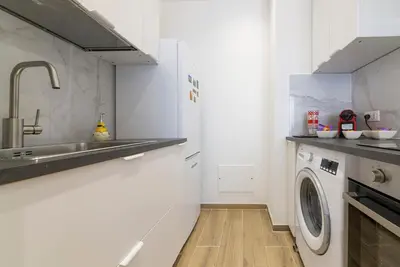 a kitchen with a sink and a washing machine at Anna's Central Apartment in Palermo