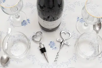 a bottle of wine and a pair of keys and wine glasses at Anna's Central Apartment in Palermo