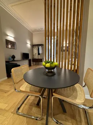 a table and chairs with a bowl of fruit on it at Galioto Sperlinga Luxury Boutique Apartments in Palermo