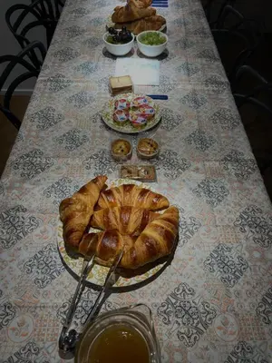 a table topped with plates of croissants and other foods at B&B Sulle Vie del Capo in Palermo