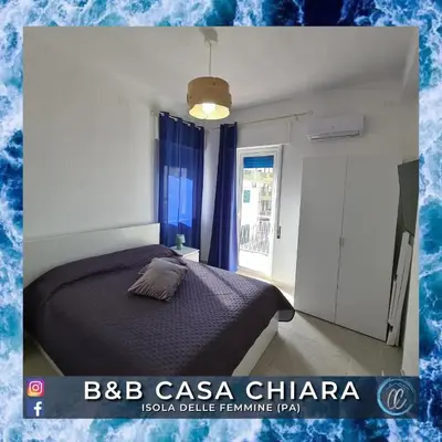a bedroom with a bed and a window at Casa Delle Femmine in Isola delle Femmine