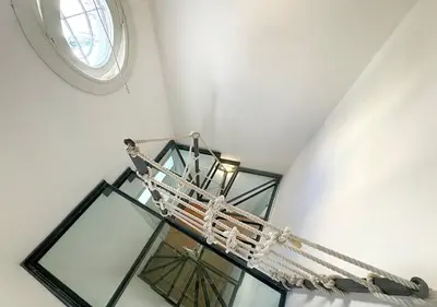 a spiral staircase with a window on the ceiling at Solemar Sicilia - Casa Eos in Porticello