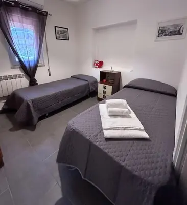 a bedroom with two beds and a window at Finc house in Palermo