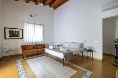 a living room with a bed and a couch at iFlat Sicilia Le terrazze blu in Palermo