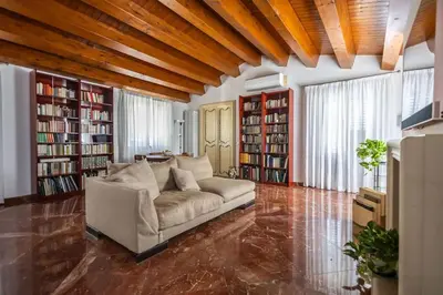 a living room with a couch and some books at iFlat Sicilia Le terrazze blu in Palermo