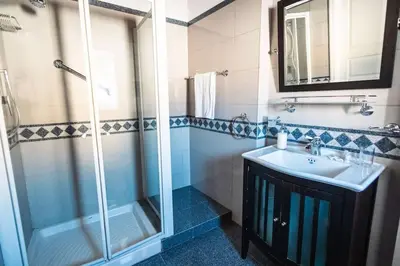 a bathroom with a sink and a shower at iFlat Sicilia Le terrazze blu in Palermo