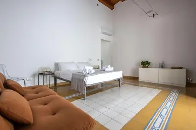 a living room with a bed and a couch at iFlat Sicilia Le terrazze blu in Palermo
