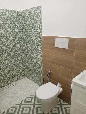 a bathroom with a toilet and a wall at Mediterranea casa vacanza in Capaci