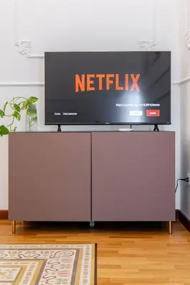a flat screen tv sitting on top of a entertainment center at Liberty Boutique Apartment in Palermo