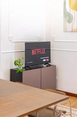 a flat screen tv sitting on top of a table at Liberty Boutique Apartment in Palermo