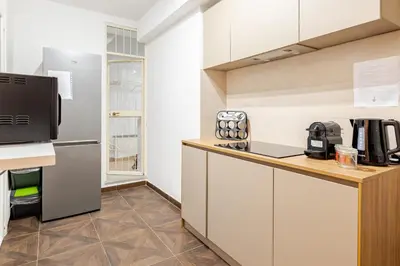 a kitchen with a counter and a refrigerator at Liberty Boutique Apartment in Palermo