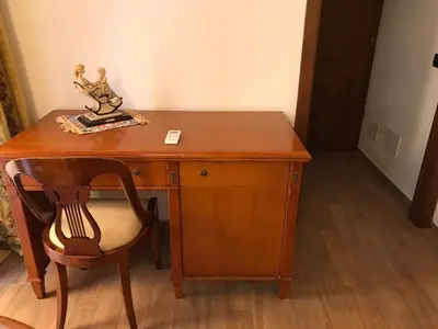 a wooden desk with a chair and a statue on it at Casa Rosa in Palermo