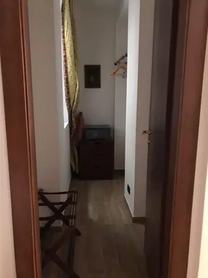 a hallway with a door leading into a room at Casa Rosa in Palermo