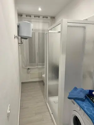 a bathroom with a shower and a washing machine at Lido Azzurro Sea Apartments in Carini