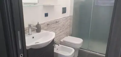 a bathroom with a sink and a toilet and a shower at Lido Azzurro Sea Apartments in Carini