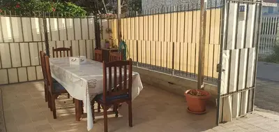 a table and chairs on a patio with a fence at Lido Azzurro Sea Apartments in Carini