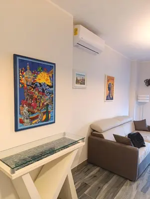 a bedroom with a glass table and a bed at Casa vacanze Rosalinda House di fronte al mare di Palermo in Palermo